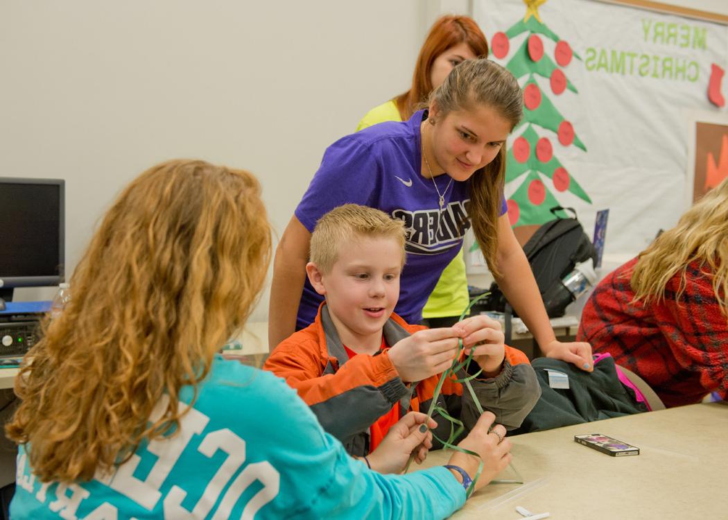 Early childhood education students teaching a child 