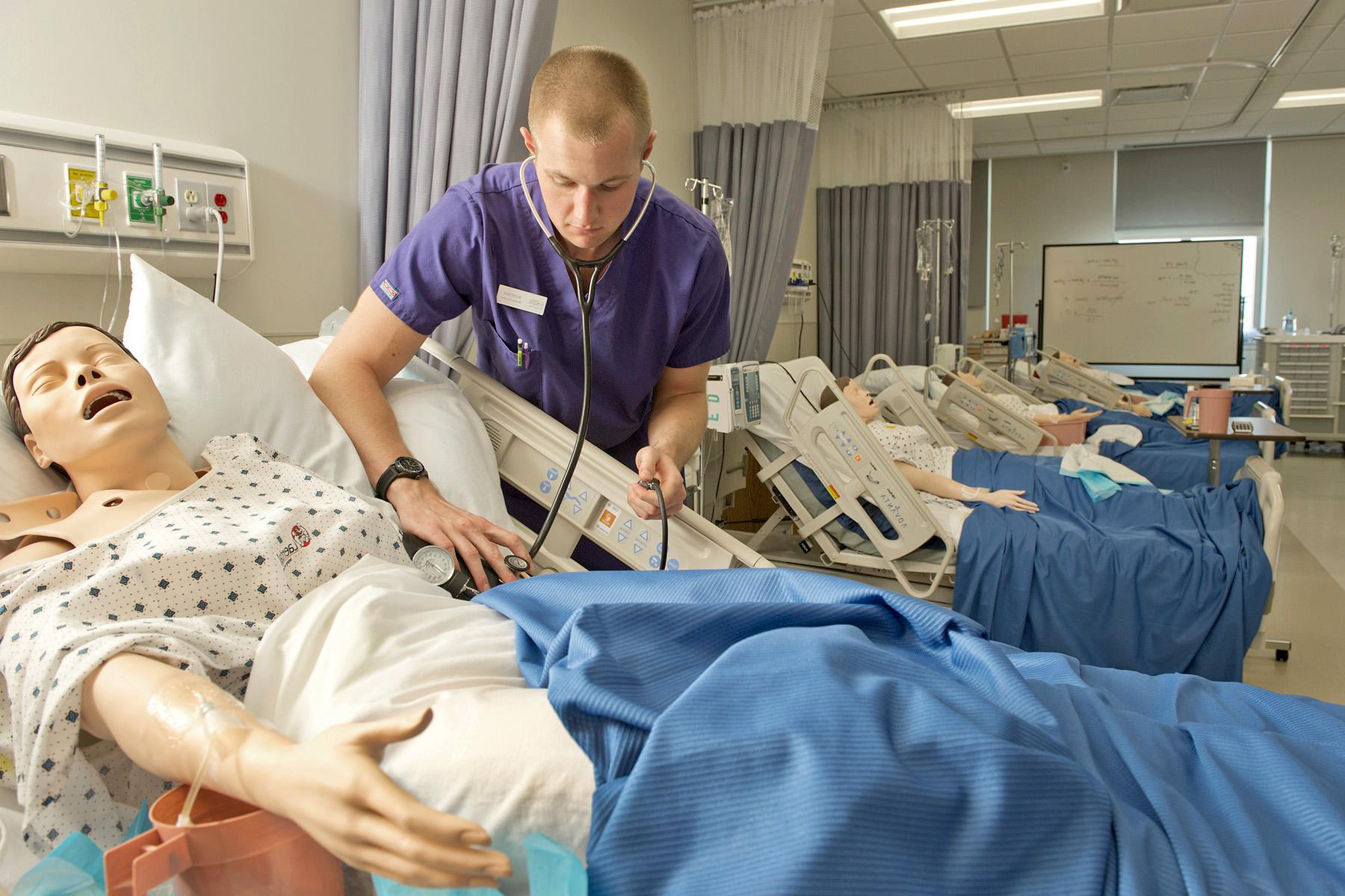 Nursing students and professor going over a project 